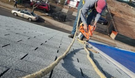 Roof repair specialists working on a detailed roof service project